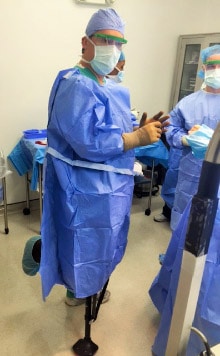 Dr. Andres M. Perez wearing an iWALK crutch during surgery - iWALKFree