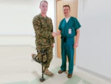 Austin in uniform with doctor while wearing the iWALK hands-free crutch iWALKFree