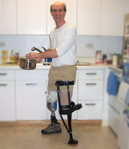 Below knee amputee wearing iWALK Hands-Free Crutch while cooking