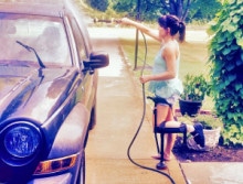 Woman washing her car while using the iWALK hands-free crutch, iWALKFree