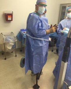 Dr. Andres M. Perez wearing an iWALK crutch during surgery - iWALKFree