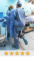 Dr. Javier Vivas standing on an iWALK crutch during surgery - iWALKFree