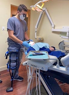 Dr David Moribito wearing the iWALK crutch while examining a patient - iWALKFree