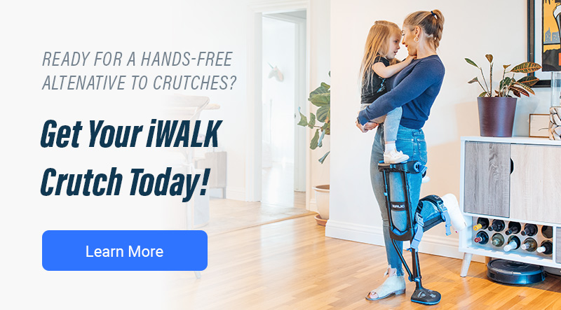 Woman holding her child while using the iWALK hands-free crutch - iWALKFree